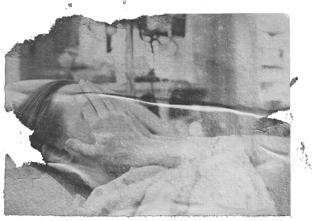 A woman in a hospital bed covering her face with her hands