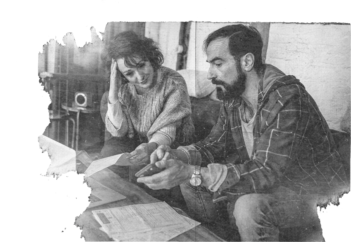 A distressed man and woman looking at their bills
