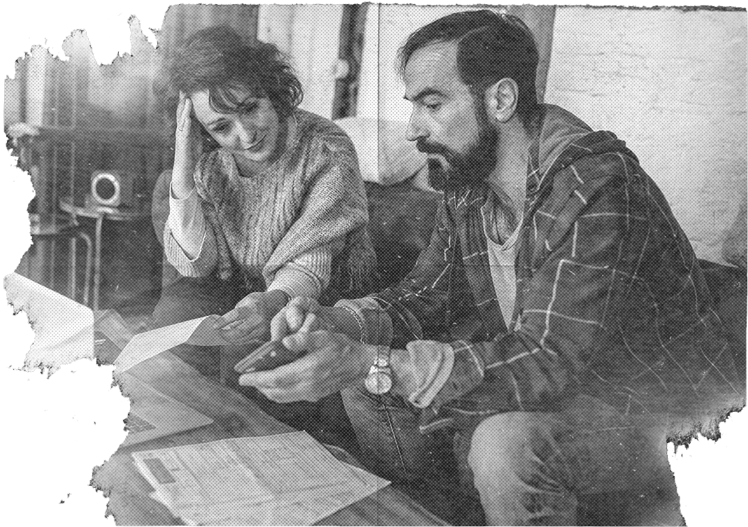 A distressed man and woman looking at their bills